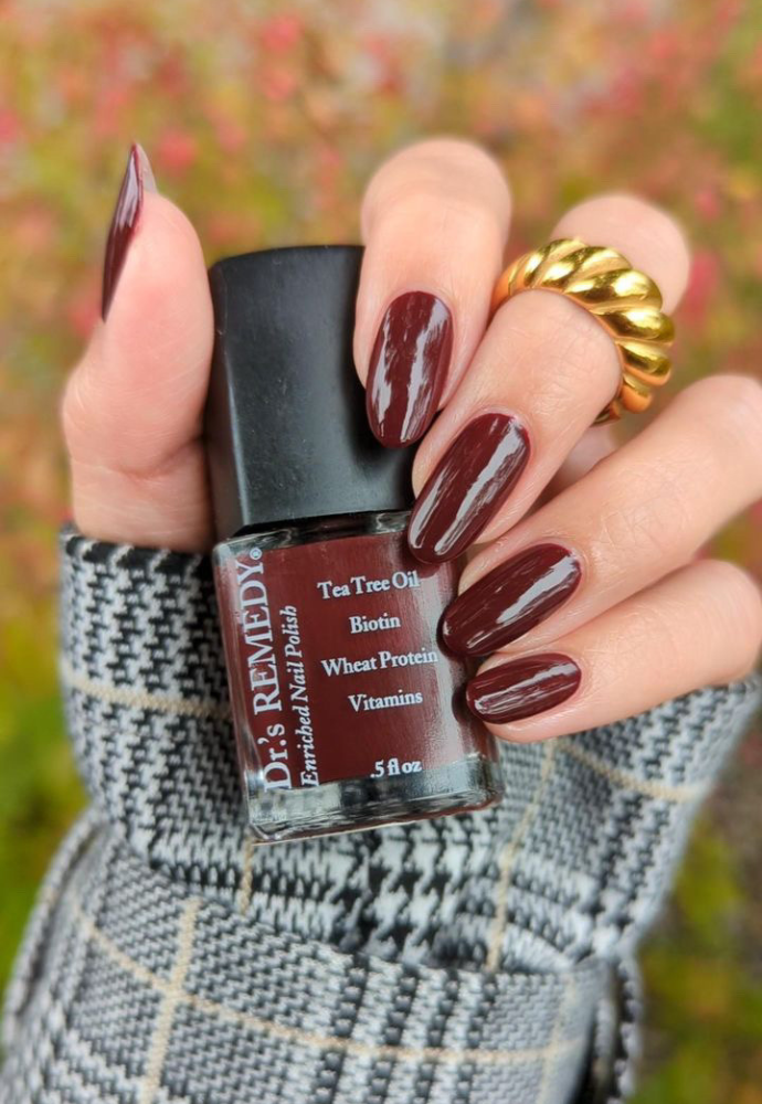 Beautiful nails holding Dr.'s Remedy Enriched Nail Polish in MEANINGFUL Merlot, a sultry blend of deep purple and red-wine burgundy infused with dark berries, enriched with Tea Tree Oil, Biotin, and Wheat Protein for healthy nails