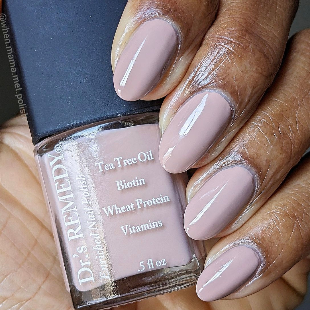 Beautiful nails holding Dr.'s Remedy Enriched Nail Polish in COZY Cafe, a cafe au lait with hints of pinkish grey and a splash of lilac shade enriched with Tea Tree Oil, Biotin, and Wheat Protein for healthy nails