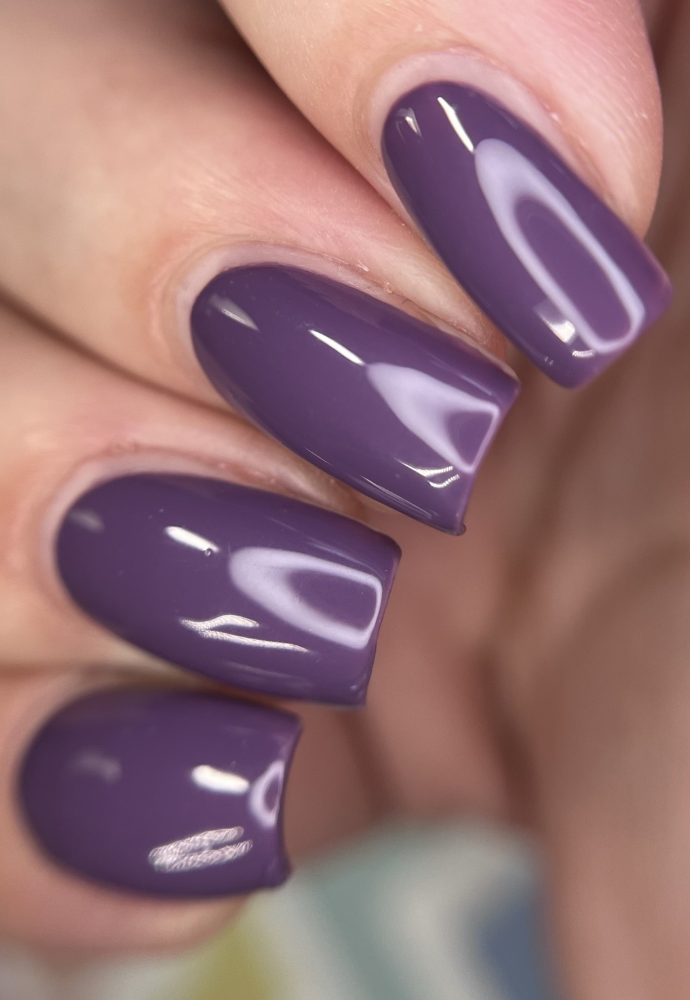 Beautiful nails painted with Dr.'s Remedy Enriched Nail Polish in PLUCKY Plum, a soft-rich, full coverage purple shade with indigo undertones, showcasing a glossy finish