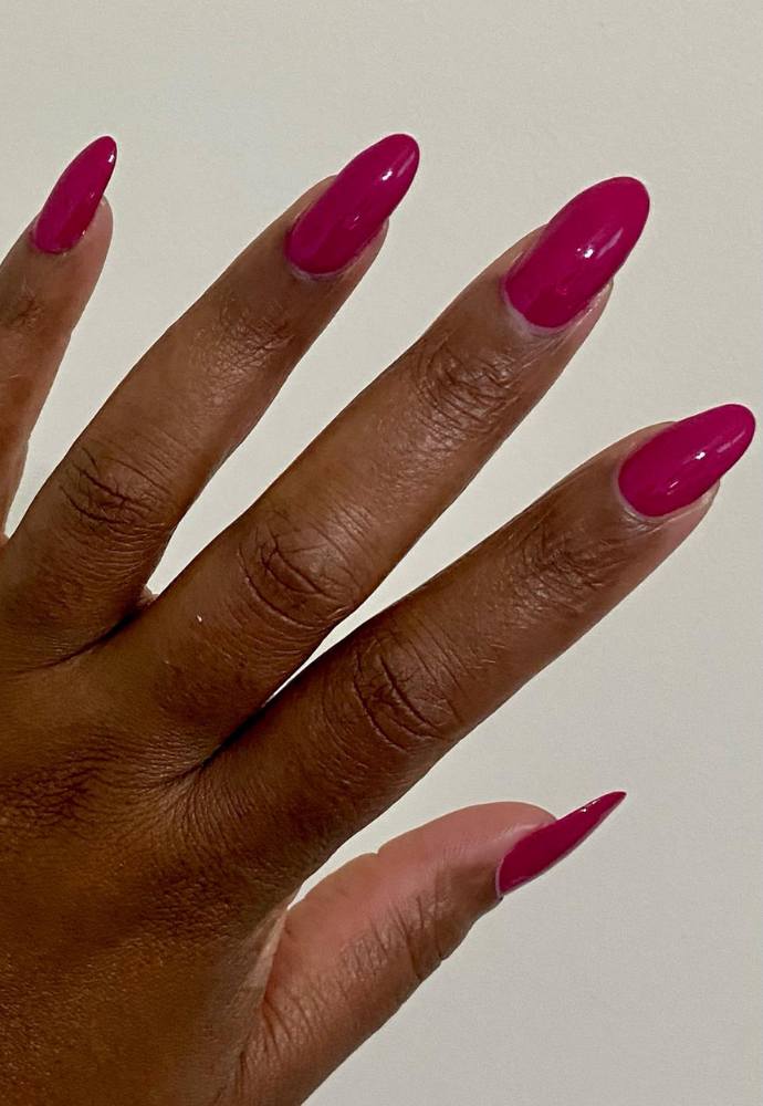 Beautiful nails painted with Dr.'s Remedy Enriched Nail Polish in FOCUS Fuchsia, a hot pink shade, showcasing a glossy finish