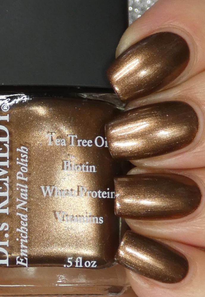 Beautiful nails holding Dr.'s Remedy Enriched Nail Polish in BOLD Bronze, a soft copper hue enriched with Tea Tree Oil, Biotin, and Wheat Protein for healthy nails