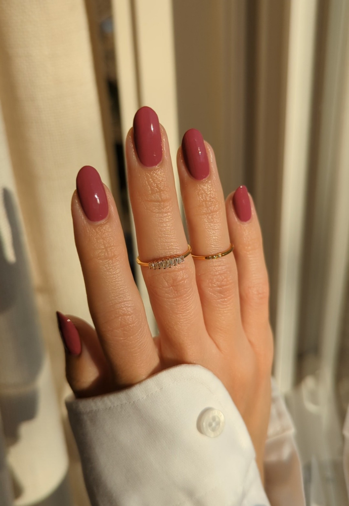 Beautiful nails painted with Dr.'s Remedy Enriched Nail Polish in BRAVE Berry, a rich fusion of berries soft shade, showcasing a glossy finish and complemented by gold rings