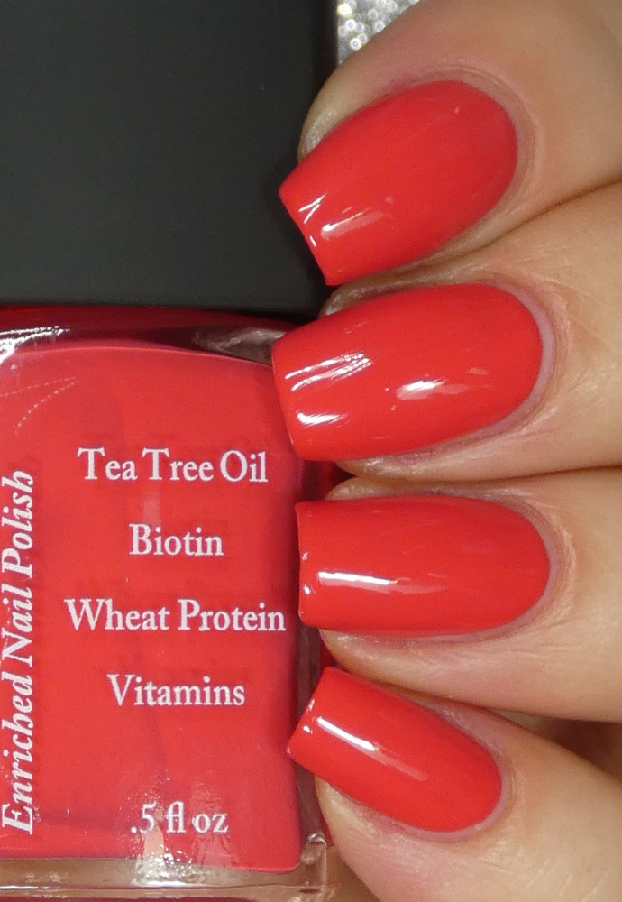Beautiful nails holding Dr.'s Remedy Enriched Nail Polish in CLARITY Coral, a bright pinky-orangey and matte shade enriched with Tea Tree Oil, Biotin, and Wheat Protein for healthy nails