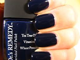 Beautiful nails holding Dr.'s Remedy Enriched Nail Polish in NOBLE Navy, a sea-at-dusk shade, enriched with Tea Tree Oil, Biotin, and Wheat Protein for healthy nails