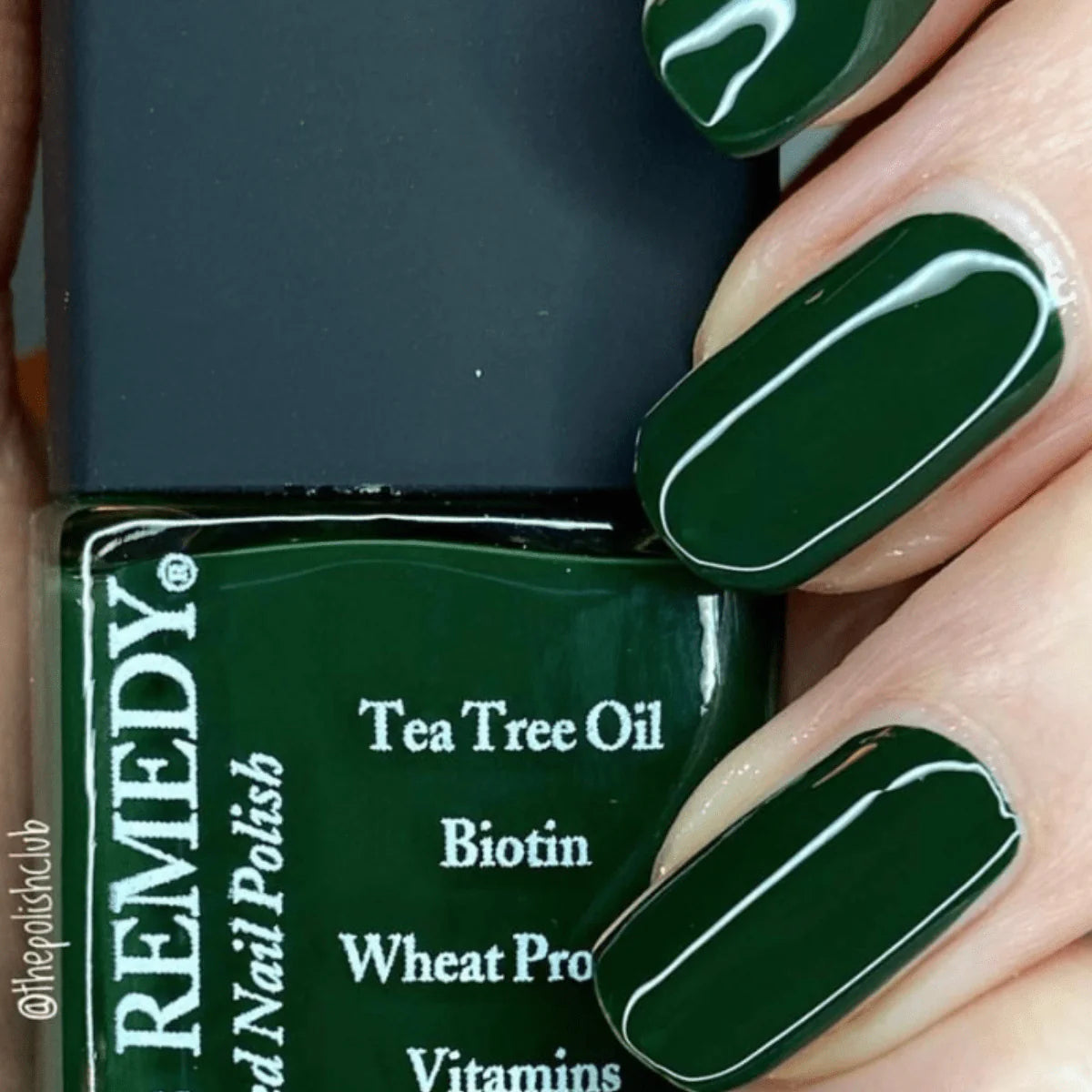 Beautiful nails holding Dr.'s Remedy Enriched Nail Polish in EMPOWERING Evergreen, a lush, deep forest green shade enriched with Tea Tree Oil, Biotin, and Wheat Protein for healthy nails