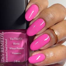 Beautiful nails holding Dr.'s Remedy Enriched Nail Polish in MAGNIFICENT Magenta, a bright, juicy, watermelon shade enriched with Tea Tree Oil, Biotin, and Wheat Protein for healthy nails