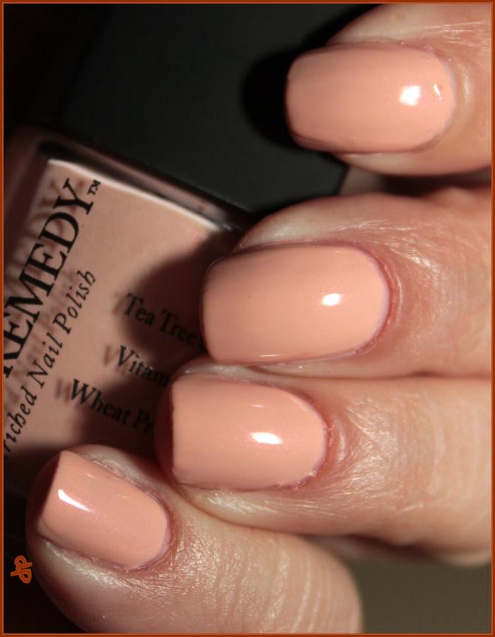 Beautiful nails holding Dr.'s Remedy Enriched Nail Polish in NURTURE Nude Pink, a barely there beautiful pink shade with a hint of iridescence, enriched with Tea Tree Oil, Biotin, and Wheat Protein for healthy nails