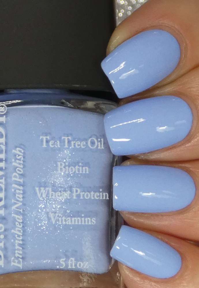 Beautiful nails holding Dr.'s Remedy Enriched Nail Polish in PERCEPTIVE Periwinkle, a pastel blue with soft lavender hue and a barely there shimmer, enriched with Tea Tree Oil, Biotin, and Wheat Protein for healthy nails