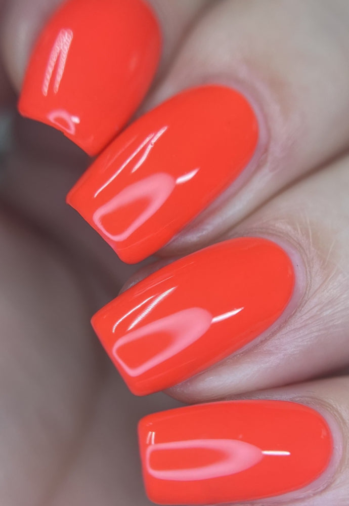 Beautiful nails painted with Dr.'s Remedy Enriched Nail Polish in GIDDY Grapefruit, a brilliant neon-like pinky-peach shade, showcasing a glossy finish 