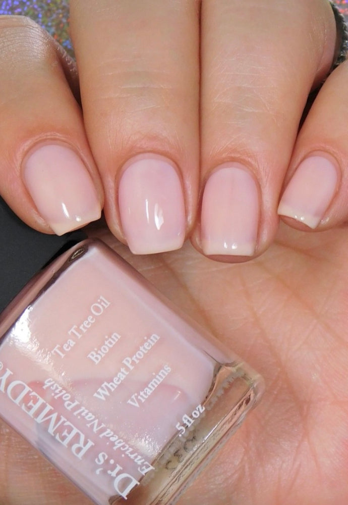 Beautiful nails holding Dr.'s Remedy Enriched Nail Polish in PERFECT Petal Pink, a classic sheer pastel shade with a touch of blush, enriched with Tea Tree Oil, Biotin, and Wheat Protein for healthy nails