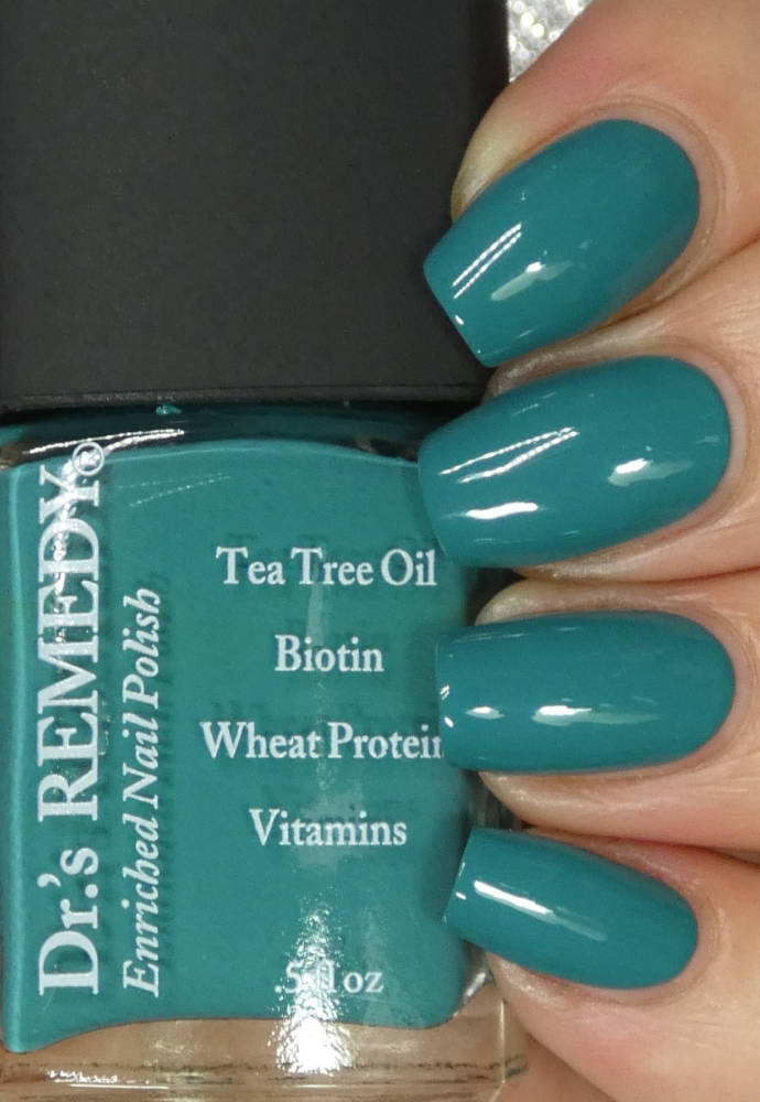 Beautiful nails holding Dr.'s Remedy Enriched Nail Polish in JUBILANT Jade, a vibrant cross between teal and jade shade enriched with Tea Tree Oil, Biotin, and Wheat Protein for healthy nails