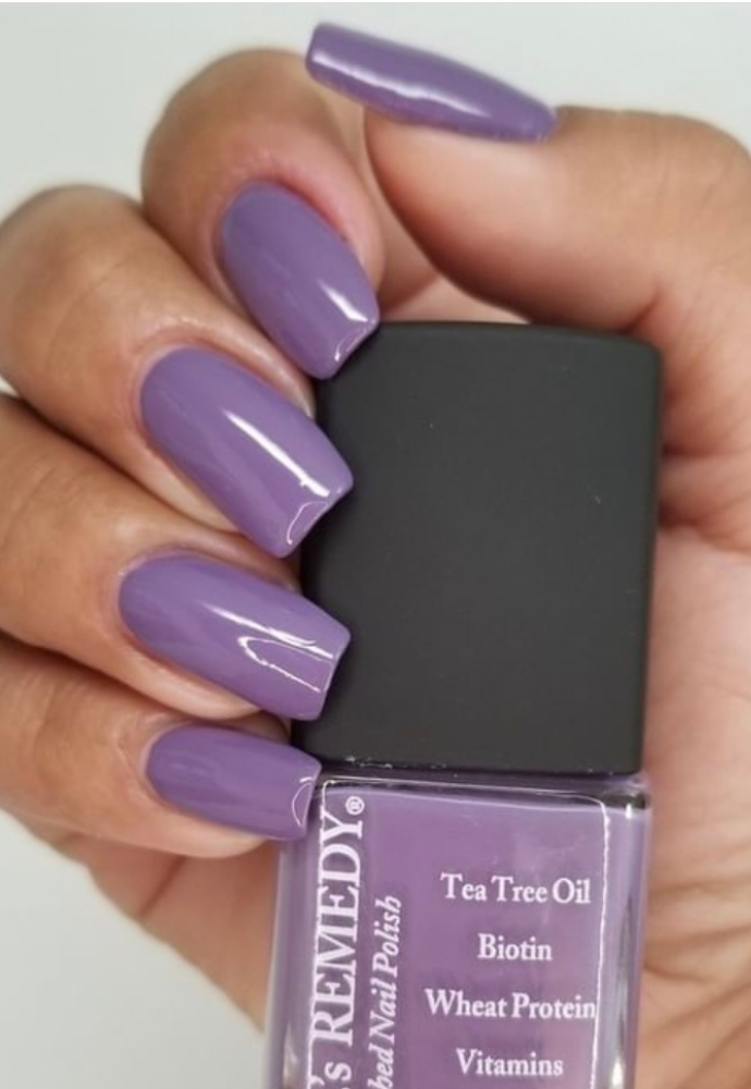 Beautiful nails holding Dr.'s Remedy Enriched Nail Polish in AMITY Amethyst, a bright, smokey purple shade enriched with Tea Tree Oil, Biotin, and Wheat Protein for healthy nails