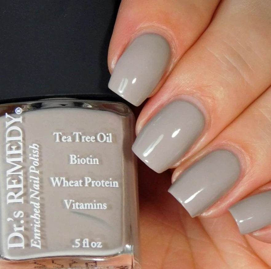 Beautiful nails holding Dr.'s Remedy Enriched Nail Polish in KINETIC Khaki, a warm taupe shade with cool tinges of green and grey enriched with Tea Tree Oil, Biotin, and Wheat Protein for healthy nails